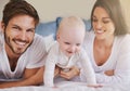 Happy family, baby and parents on bed for love, care and quality time together at home. Mom, dad and cute newborn child Royalty Free Stock Photo