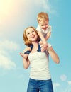 Happy family. baby sits astride the shoulders of the mother and