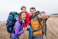 Happy family with backpacks taking selfie