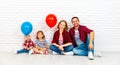 Happy family with ballons. mother, father, son, daughter on a white blank wall Royalty Free Stock Photo