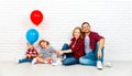 Happy family with ballons. mother, father, son, daughter on a white blank wall Royalty Free Stock Photo