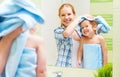 Happy family in bathroom. mother of a child with towel dry hair