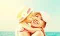 Happy family on beach. baby daughter kissing mother Royalty Free Stock Photo