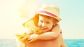 Happy family on the beach. baby girl hugging her mother Royalty Free Stock Photo