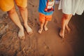 Happy family on the beach. Closeup of family feet with boy baby walking on sand. Man and woman holding their baby. Walk by the Royalty Free Stock Photo