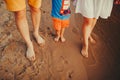 Happy family on the beach. Closeup of family feet with boy baby walking on sand. Man and woman holding their baby. Walk by the Royalty Free Stock Photo