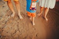 Happy family on the beach. Closeup of family feet with boy baby walking on sand. Man and woman holding their baby. Walk by the Royalty Free Stock Photo