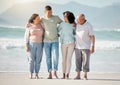 Happy family, beach and couple with senior parents hug, walk and bond in nature together. Walking, love and laughing