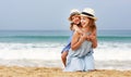 Happy family at beach. mother and child daughter hug at sea Royalty Free Stock Photo