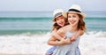 Happy family at beach. mother and child daughter hug at sunset Royalty Free Stock Photo