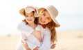 Happy family at beach. mother and child daughter hug at sunset Royalty Free Stock Photo