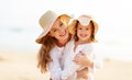 Happy family at beach. mother and child daughter hug at sunset Royalty Free Stock Photo