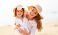 Happy family at beach. mother and child daughter hug at sunset Royalty Free Stock Photo