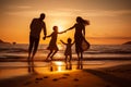 Happy family on the beach. Parents and their children are playing together at sunset Royalty Free Stock Photo