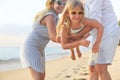 Happy family on the beach. People having fun on summer vacation. Father, mother and child against blue sea and beach background Royalty Free Stock Photo