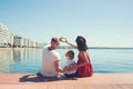 Happy family on the beach. People having fun on summer vacation. Father mother and child against blue sea and sky Royalty Free Stock Photo