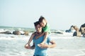 Happy family on beach playing, father with son walking sea coast, rocks behind smiling taking vacation Royalty Free Stock Photo