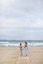 Happy family on beach vacation. Back view of mother and little daughter are walking together and holding hands on beach Royalty Free Stock Photo