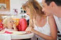 Happy family with blond little girl eating bread