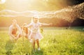 Happy family blowing a bubbles in a spring park Royalty Free Stock Photo