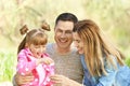 Happy family blowing soap bubbles in park Royalty Free Stock Photo