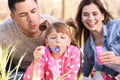 Happy family blowing soap bubbles in park Royalty Free Stock Photo