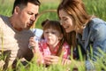 Happy family blowing soap bubbles in park Royalty Free Stock Photo