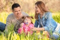 Happy family blowing soap bubbles in park Royalty Free Stock Photo