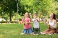 Happy family blowing soap bubbles in park Royalty Free Stock Photo