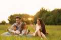 Happy family blowing soap bubbles in park at sunset Royalty Free Stock Photo