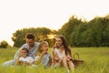 Happy family blowing soap bubbles in park at sunset Royalty Free Stock Photo