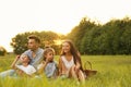 Happy family blowing soap  in park at sunset. Summer picnic Royalty Free Stock Photo