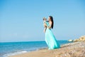 Happy family in a blue dress. Mother with baby on the beach Royalty Free Stock Photo