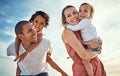 Happy family, blue sky and ocean, piggy back and hug for couple with kids on summer holiday at beach. Love, family and Royalty Free Stock Photo