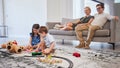 Happy family, bonding and children playing in living room, relax and cheerful in their home together. Loving parents Royalty Free Stock Photo