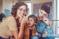 Family Breakfast. Young attractive family having breakfast at home sitting on a sofa. Royalty Free Stock Photo