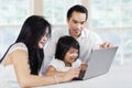 Happy family browsing internet with laptop Royalty Free Stock Photo