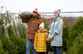 Happy family buying christmas tree at market Royalty Free Stock Photo