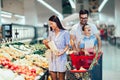 Family buying fruit at grocery store or supermarket - shopping, food, sale, consumerism