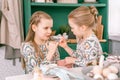 Happy family candid little kids sisters girls together playful pinkie swear and have fun ready and waiting springtime Easter holid Royalty Free Stock Photo