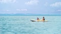 Happy family canoeing in a kayak smiling on holidays. Adventure travel with empty copy space Royalty Free Stock Photo