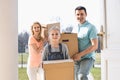 Happy family with cardboard boxes entering new home Royalty Free Stock Photo