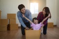 Happy family with cardboard boxes in new house at moving day Royalty Free Stock Photo