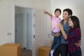Happy family with cardboard boxes in new house at moving day Royalty Free Stock Photo