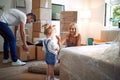 Family with cardboard boxes unpacking in their new home Royalty Free Stock Photo