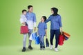 Happy family carrying shopping bags on studio Royalty Free Stock Photo