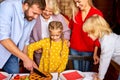 Happy family carving christmas pie together