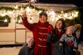 Happy family celebrates christmas in nature and holds sparklers. Parents with three sons travels in a van. Royalty Free Stock Photo