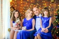 Happy family celebrating Christmas at home sitting on a sofa Royalty Free Stock Photo