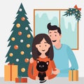 Happy family celebrating Christmas. Love couple with black cat with bow. Christmas tree, gift box presents, fir tree decoration.